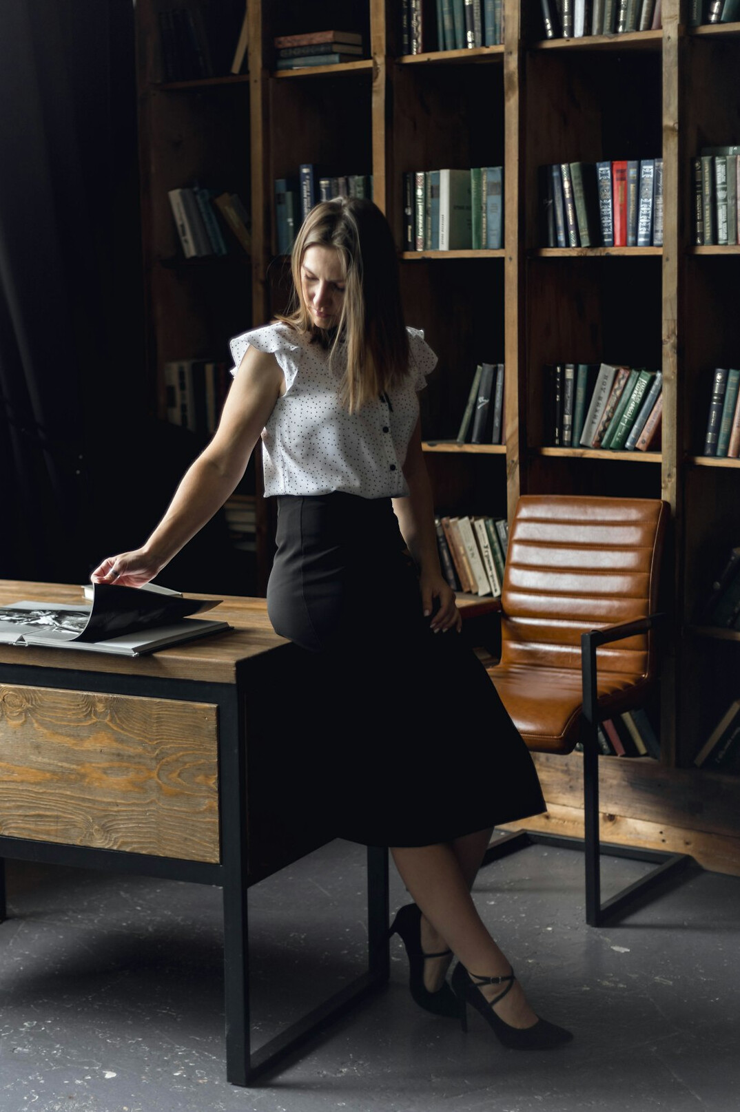 woman reading book at desk