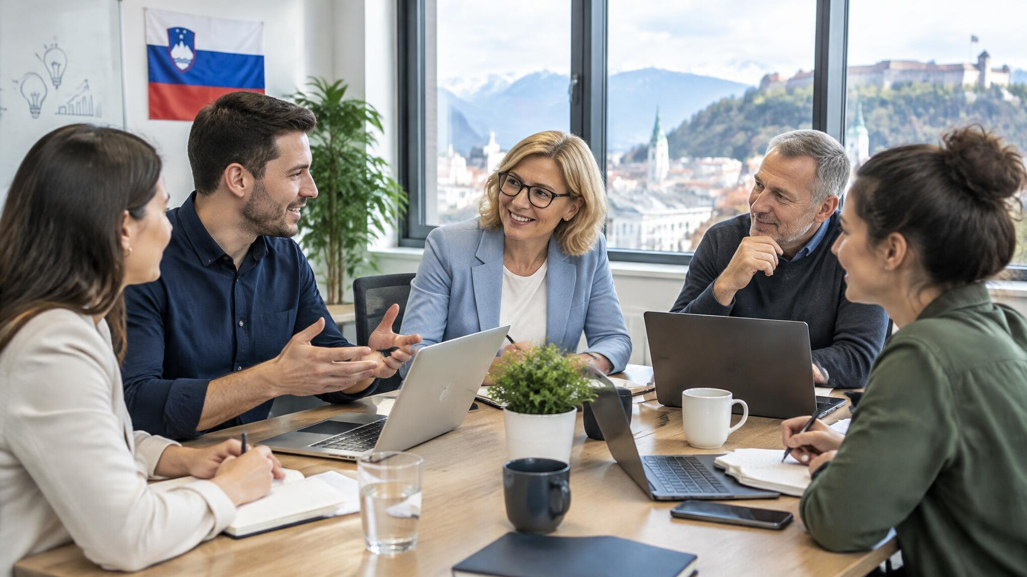 Business team meeting around a table with laptops